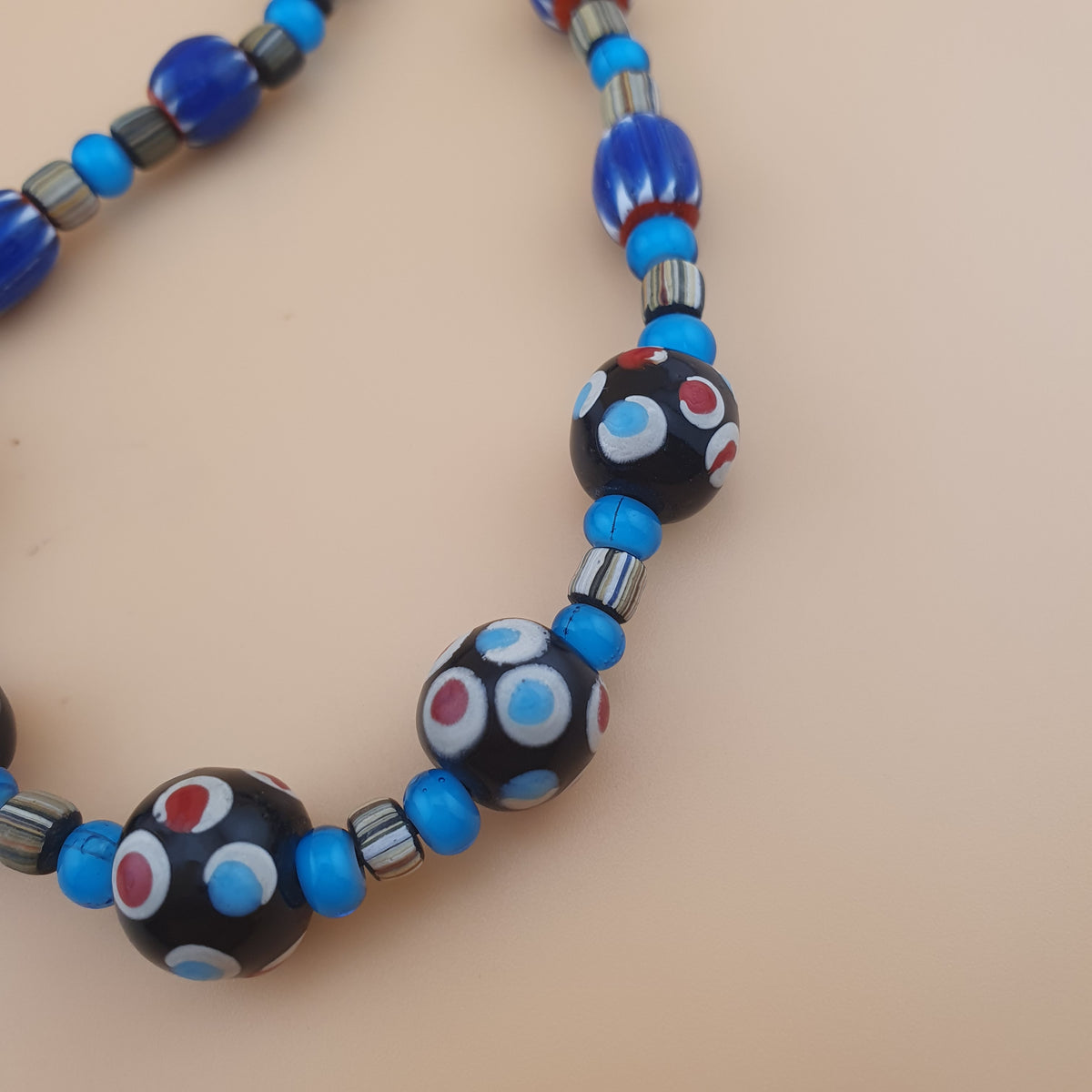 Collier en perles de verre vintage, motif chevron et cœur blanc avec yeux