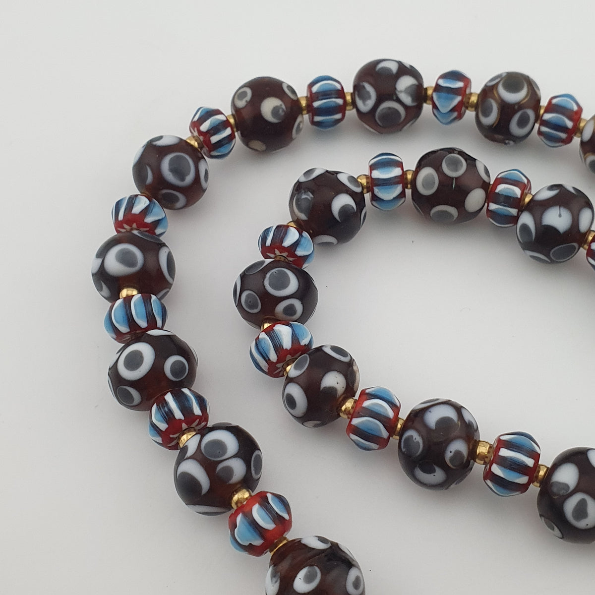 Collier de perles de verre style vénitien vintage, avec motifs yeux et chevrons
