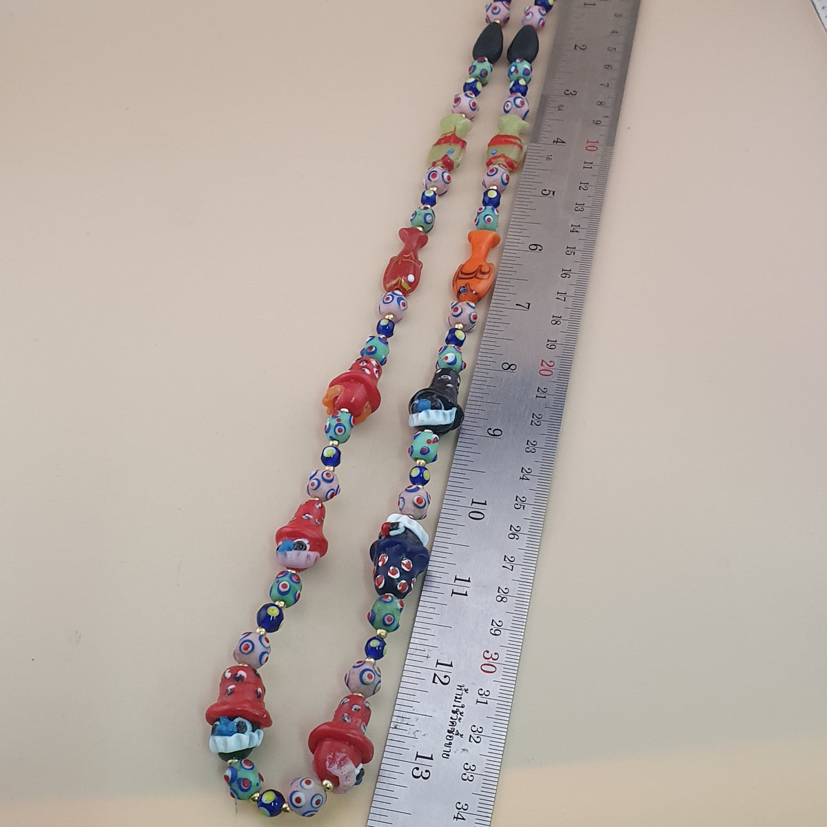 Collier de perles en verre vintage style vénitien avec yeux de mouffette et vieux visage